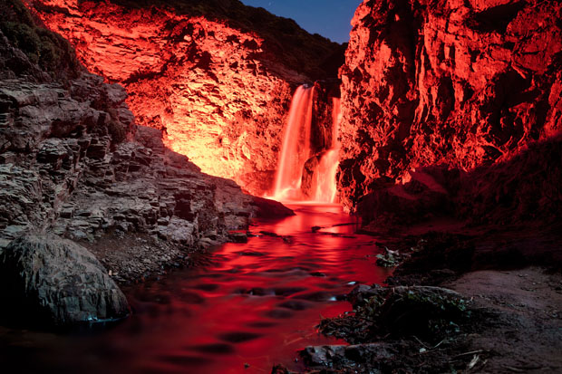 Colorful Long Exposure Photos of Glow Sticks Dropped Into Waterfalls glowwaterfall 7